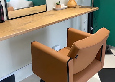 Modern salon chair and wooden counter at Hello Happiness Hair (by Elrae), Cape Town, Western Cape, ZA.