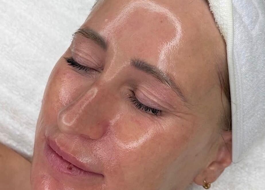 Client receiving a relaxing facial at Cove Skin Clinic, Rainham, England, GB, showcasing radiant skin.