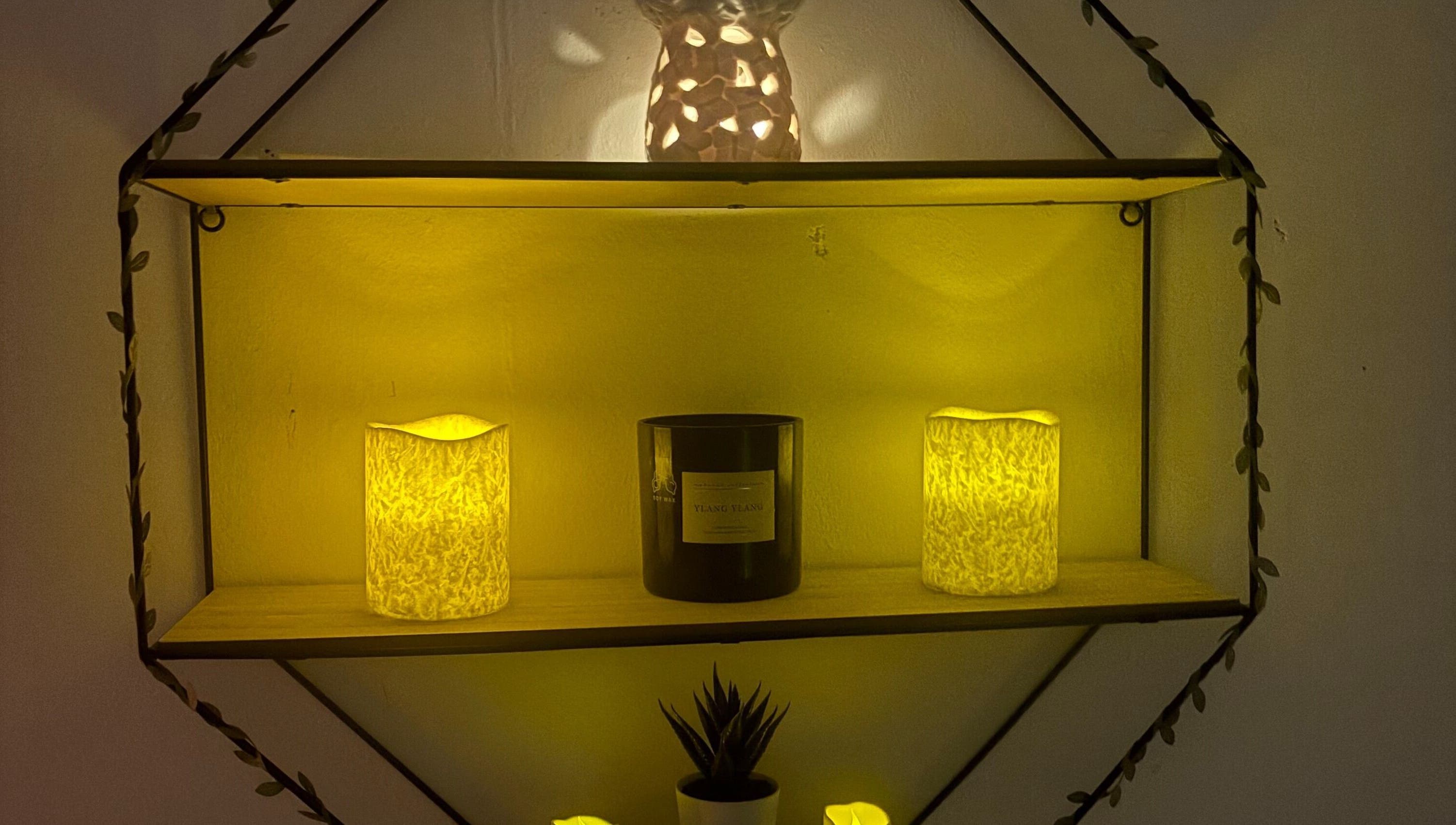 Warm glow from candles and decor on a shelf at Wellness by Tamara, Kidderminster, England, GB.