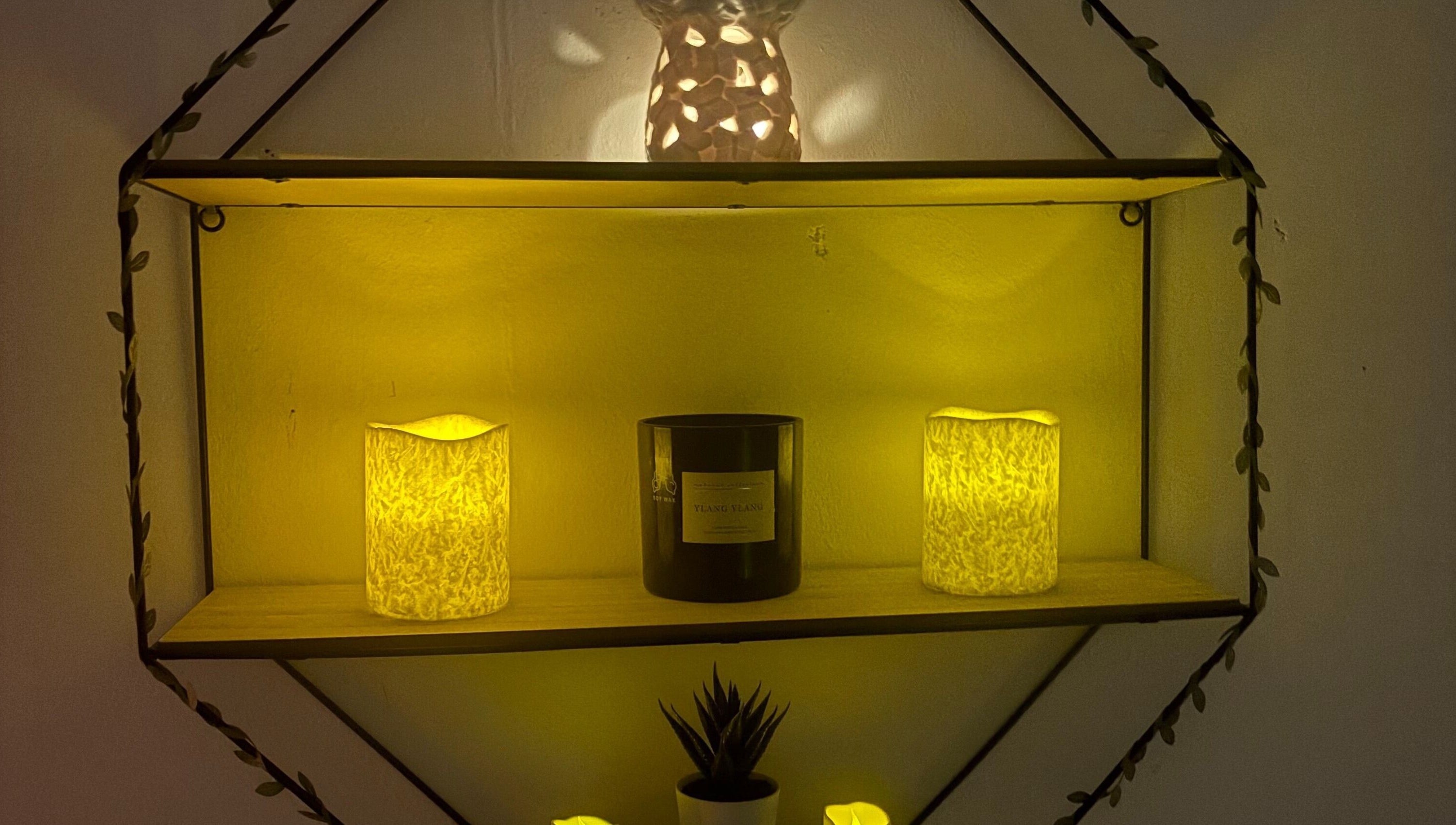 Warm glow from candles and decor on a shelf at Wellness by Tamara, Kidderminster, England, GB.