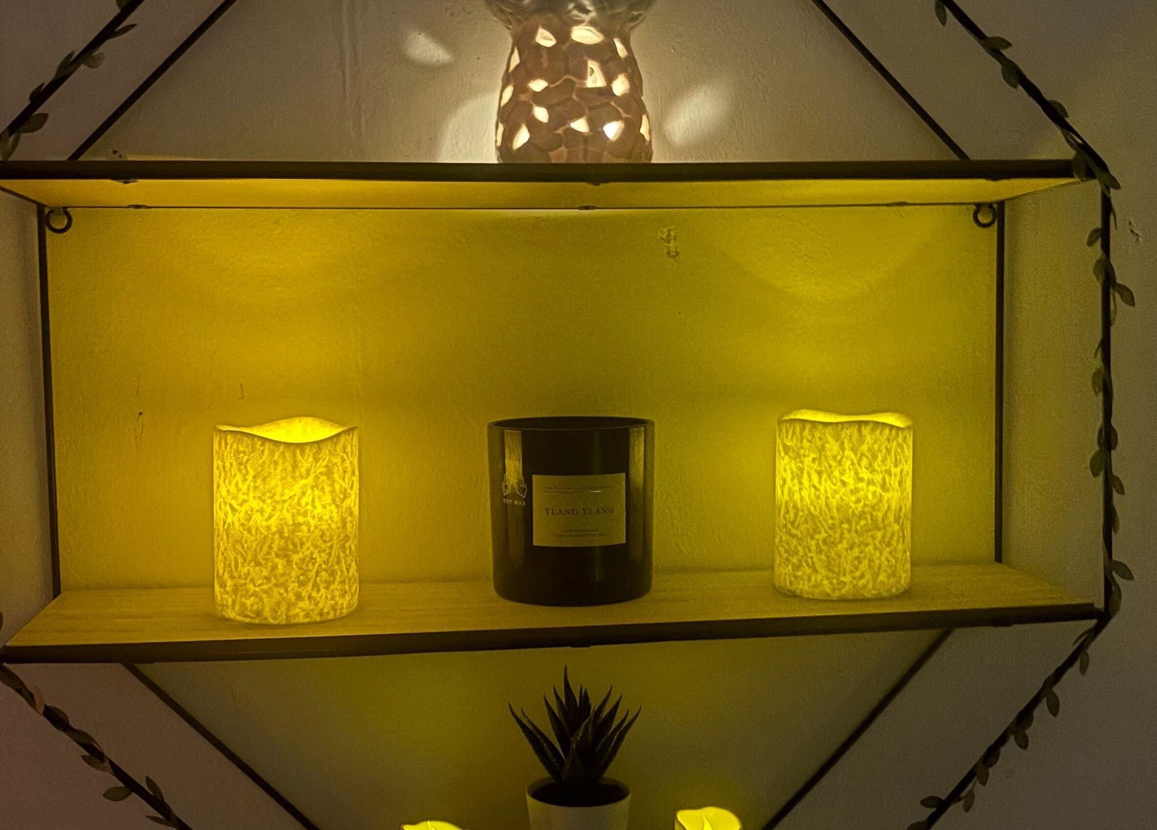 Warm glow from candles and decor on a shelf at Wellness by Tamara, Kidderminster, England, GB.