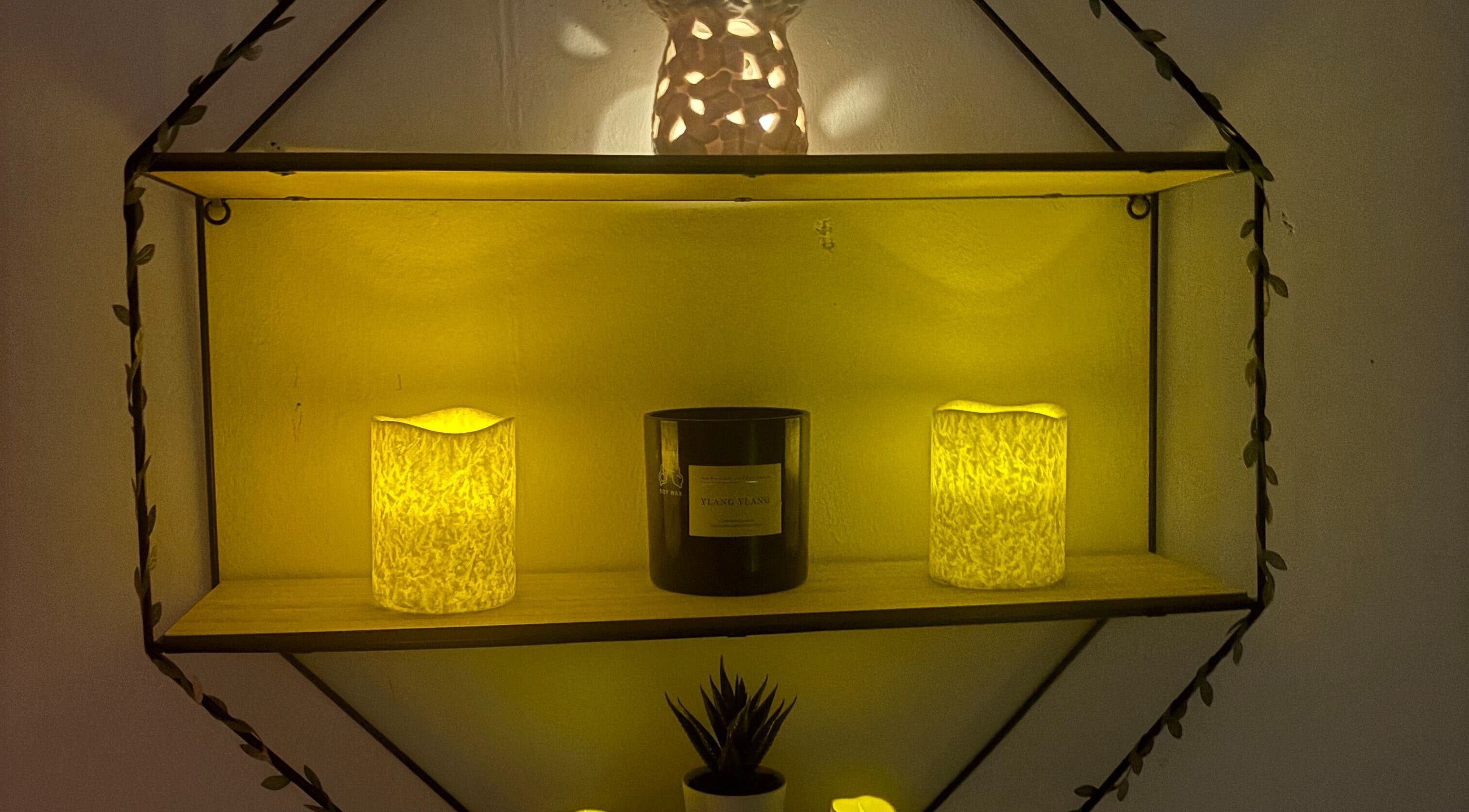 Warm glow from candles and decor on a shelf at Wellness by Tamara, Kidderminster, England, GB.
