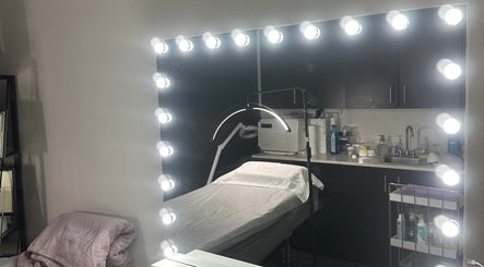 Elegant skincare treatment room at LUXURY SKINCARE STUDIO, Bloomington, Minnesota, US with illuminated mirror.