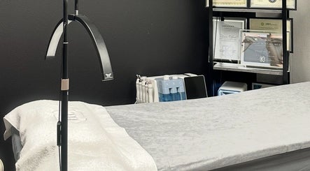 Treatment room at LUXURY SKINCARE STUDIO in Bloomington, Minnesota, US with bed and awards.