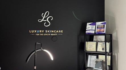 Decorated wall at Luxury Skincare Studio, Bloomington, Minnesota, US, featuring certificates and branding.