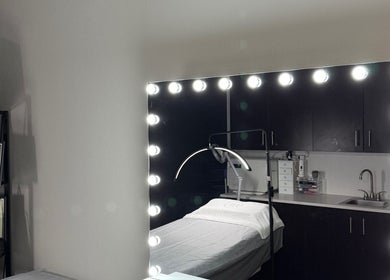 Elegant skincare room at Luxury Skincare Studio, Bloomington, Minnesota, US, featuring a lit mirror.