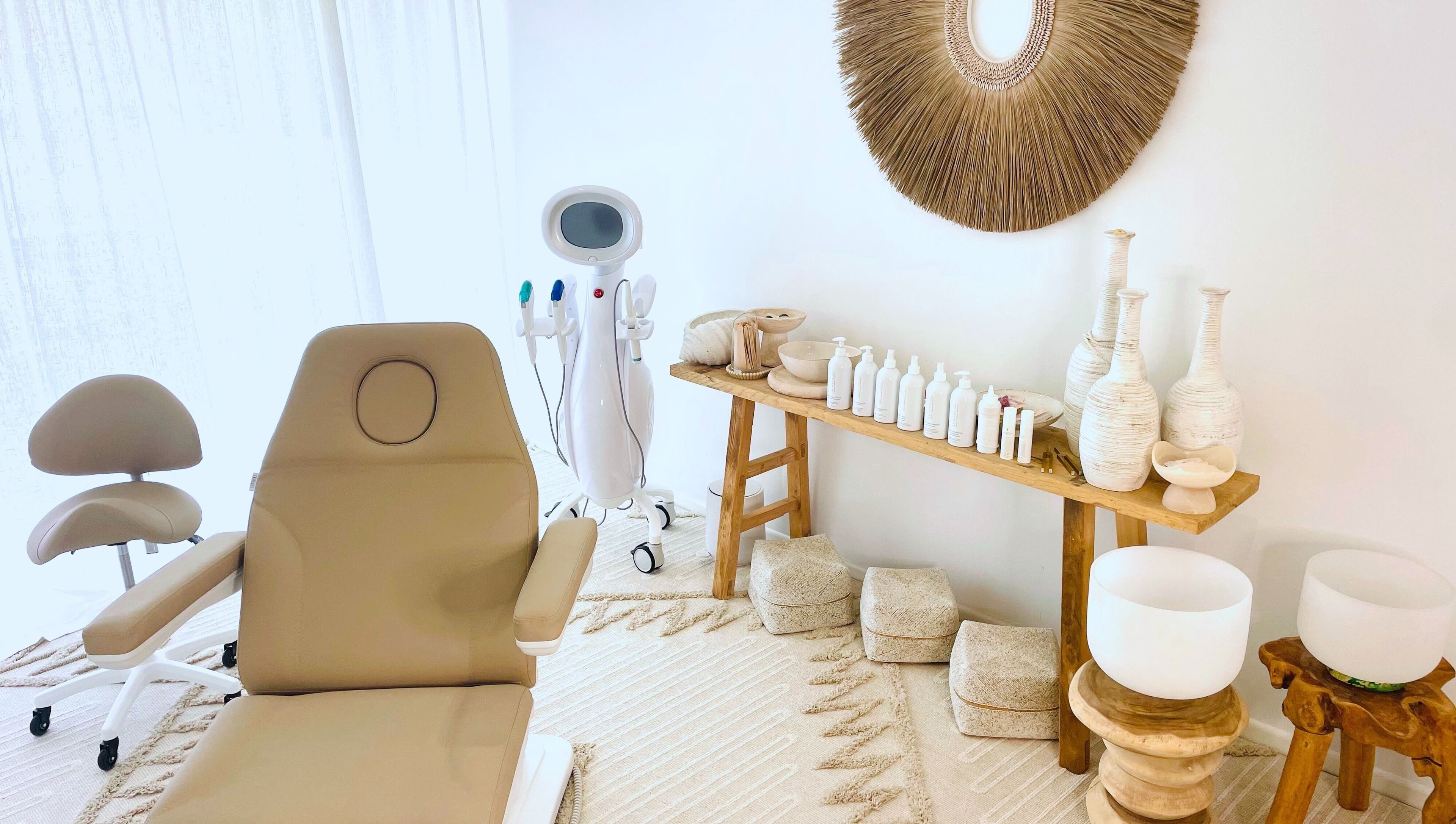 Chic spa interior at The Sound Studio, Palm Beach, Queensland, AU with cozy treatment chair and decor.