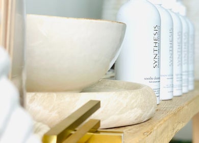 Elegant beauty products on natural wood shelf at The Sound Studio, Palm Beach, Queensland, AU.