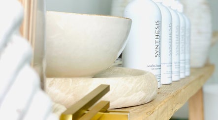 Elegant beauty products on natural wood shelf at The Sound Studio, Palm Beach, Queensland, AU.