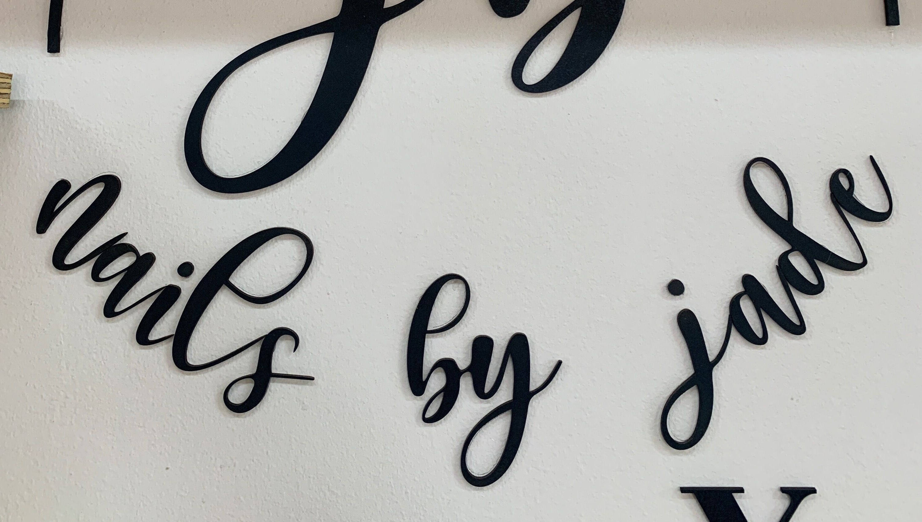 Elegant wall sign at Nails By Jade in Pietermaritzburg, Kwazulu-natal, ZA, showcasing artistic lettering.