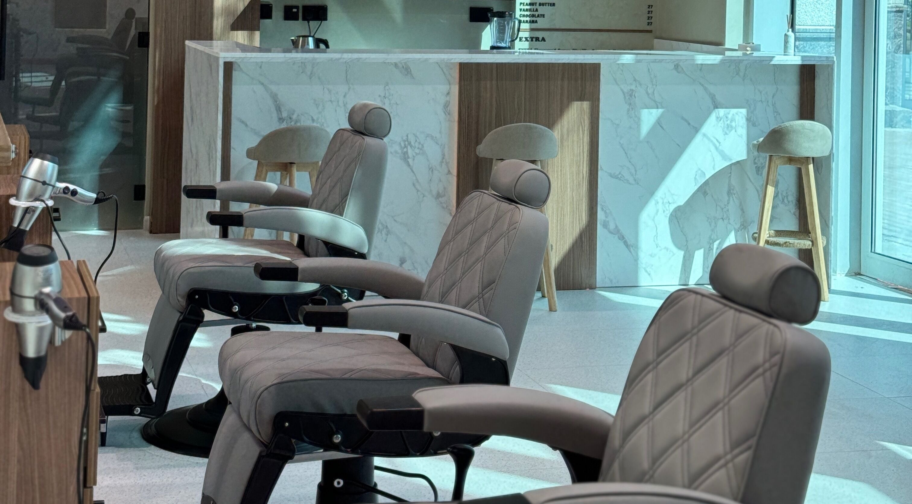 Modern salon chairs in Hair Club Gents Salon, Dubai, Dubai, AE, featuring elegant design and comfort.