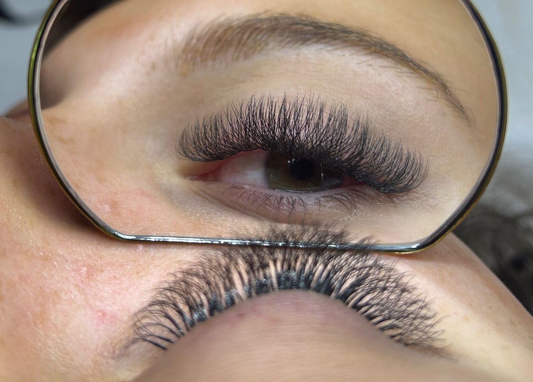 Expert eyelash extensions at Nancy’s Lashes and Brows, Clacton-on-sea, England, GB, shown in a close-up reflection.