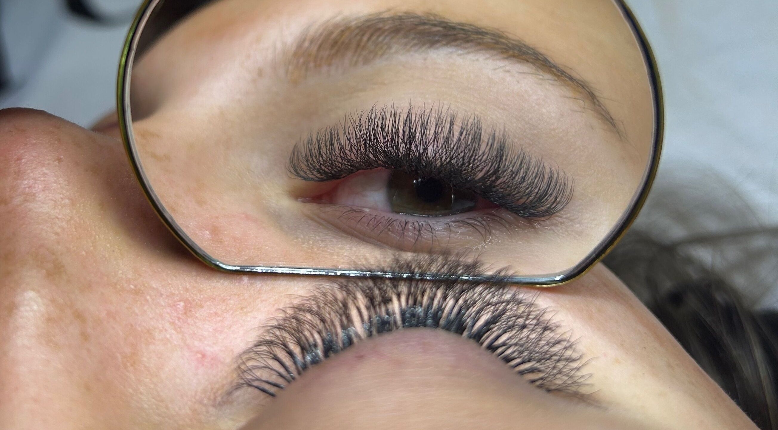 Expert eyelash extensions at Nancy’s Lashes and Brows, Clacton-on-sea, England, GB, shown in a close-up reflection.