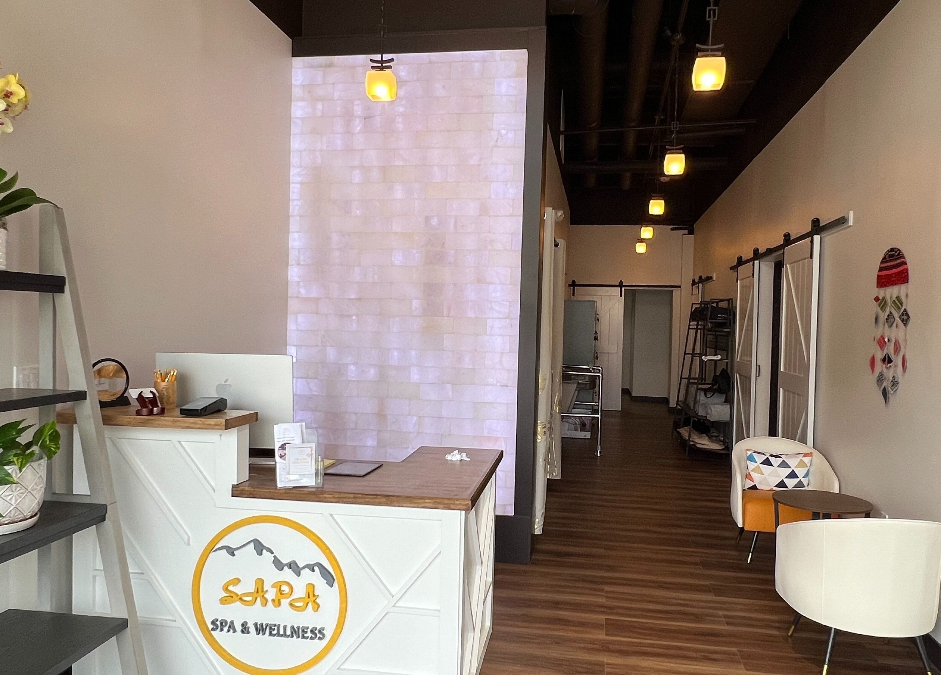 Reception area of Sapa Wellness Workshops in Denver, Colorado featuring inviting decor and serene lighting.