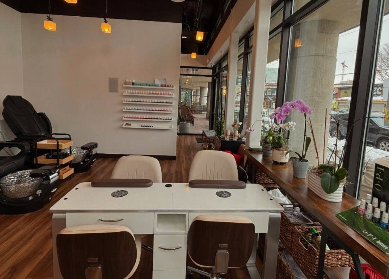 Elegant interior of Sapa Spa and Wellness, Denver, Colorado, US with cozy seating and nail care displays.