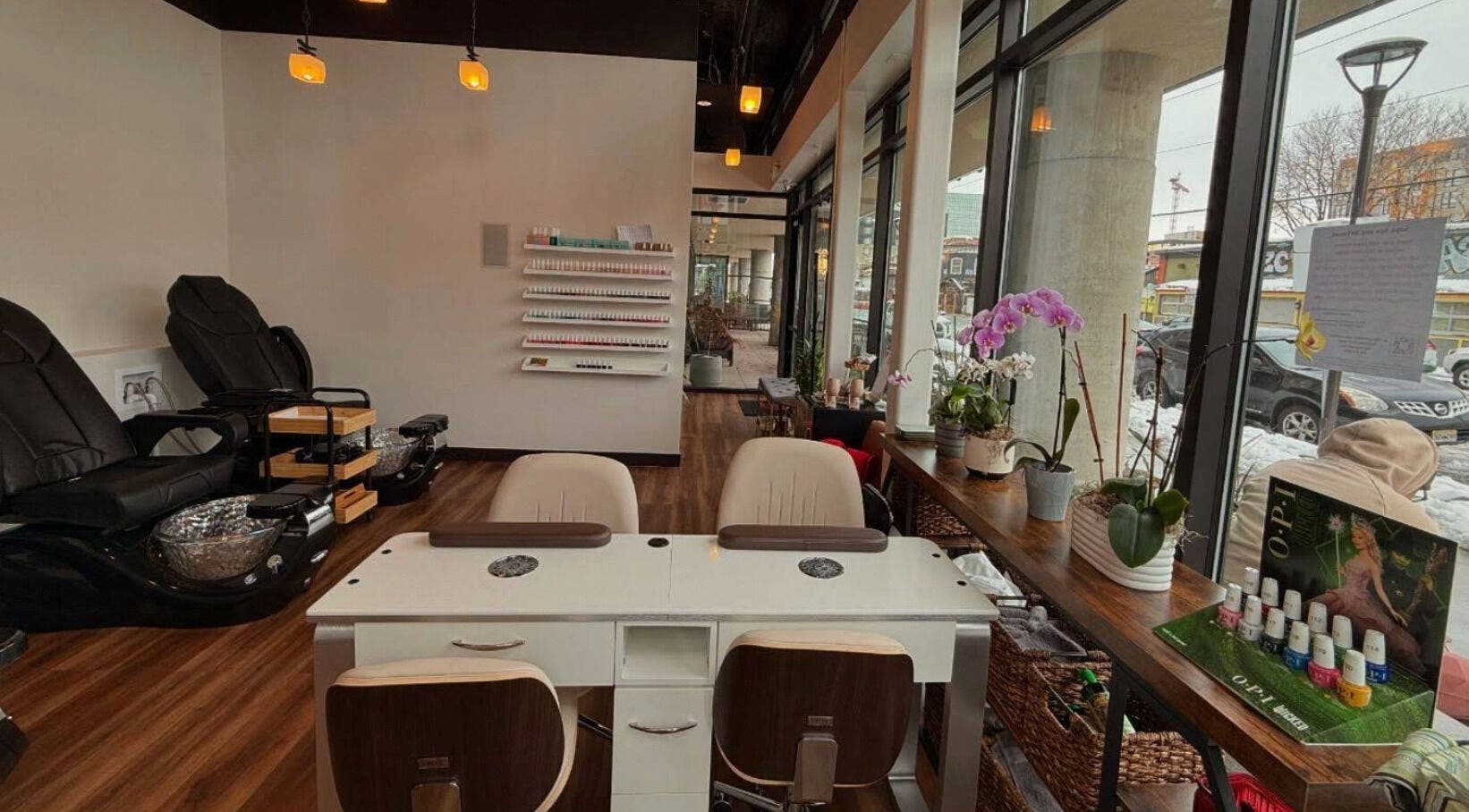 Elegant interior of Sapa Spa and Wellness, Denver, Colorado, US with cozy seating and nail care displays.