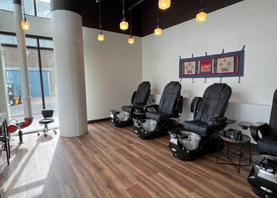 Relaxing pedicure area at Sapa Spa and Wellness, Denver, Colorado, US with plush seating and modern decor.