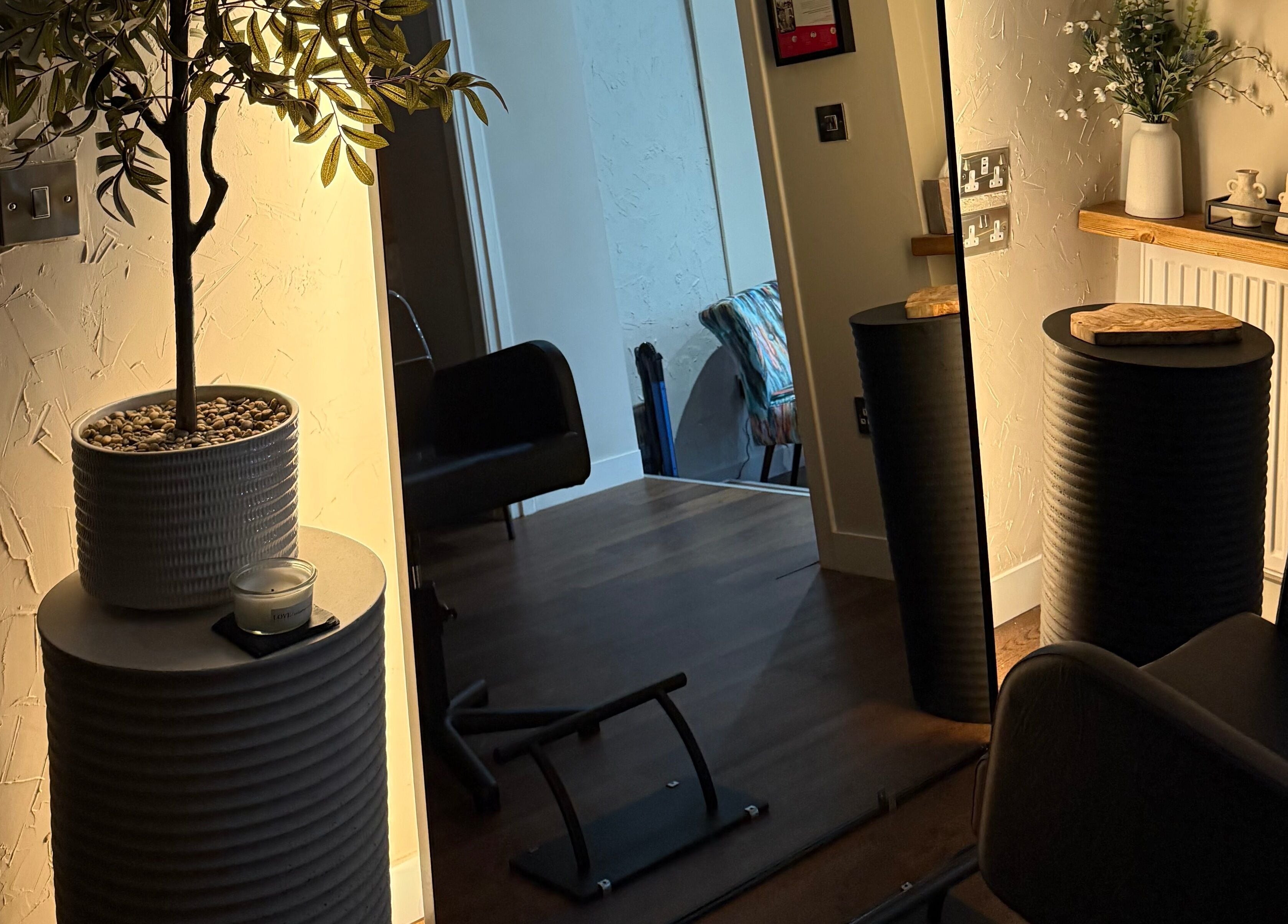 Elegant interior of Megan Sutherland Hair, Bathgate, Scotland, featuring stylish chairs and decor.