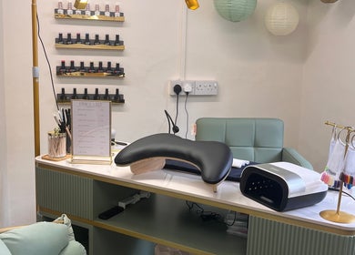 Sophisticated manicure station at Nails by Kara May in Bridport, England, GB, showcasing nail polishes and equipment.