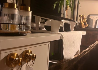 Stylish nail care setup at Nails by Kara May, Bridport, England, GB featuring golden decor and certificates.