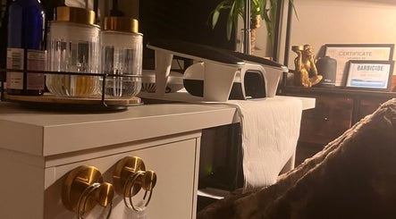 Stylish nail care setup at Nails by Kara May, Bridport, England, GB featuring golden decor and certificates.