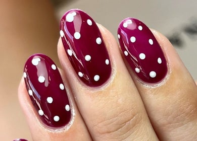 Polka dot nails styled at Polished by Jasmin in Worcester, England, GB. Trendy nail art with white dots.