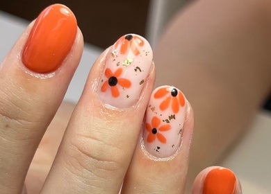 Floral nail art with orange and black design at Polished by Jasmin, Worcester, England, GB.