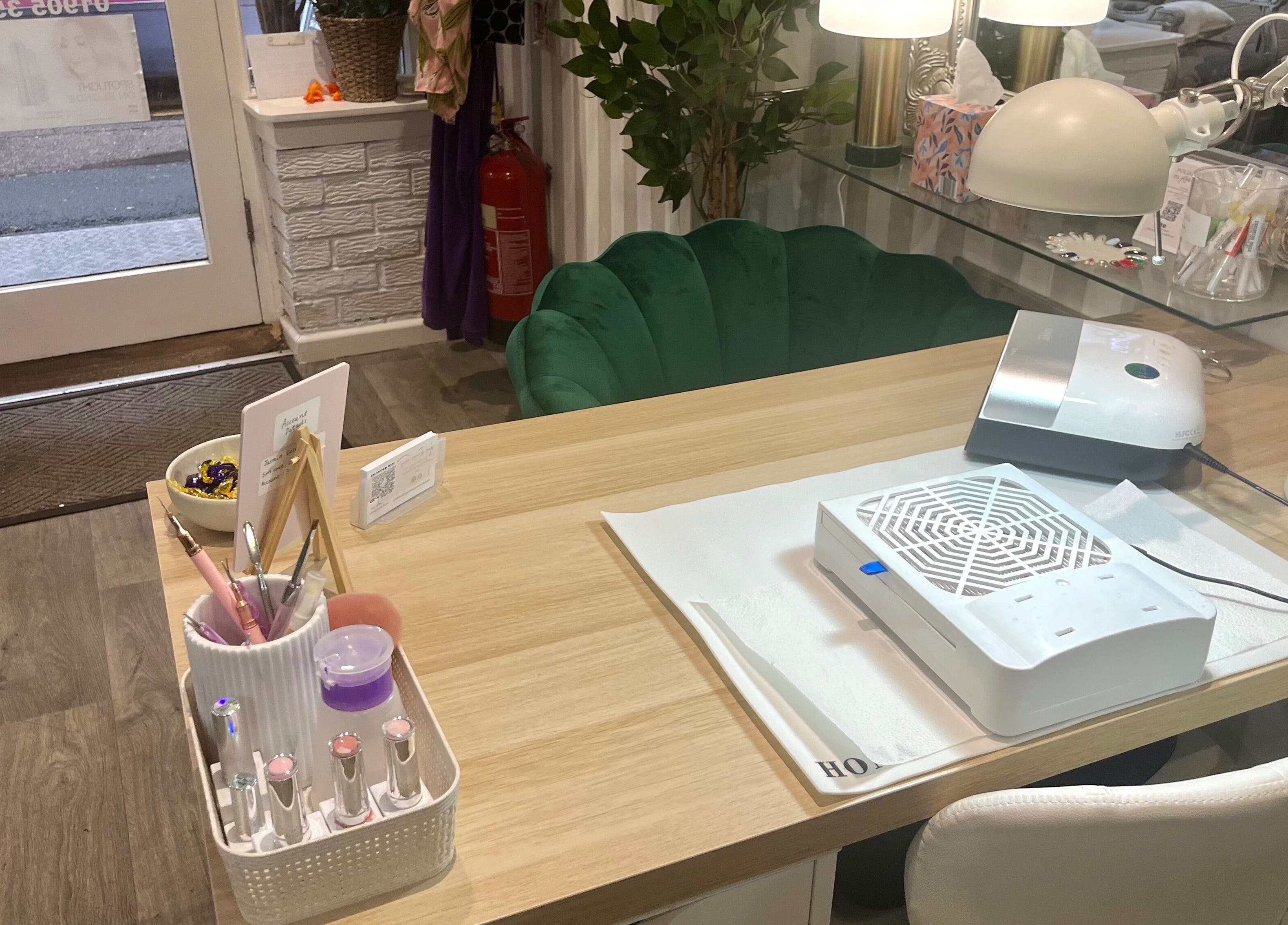 Nail station setup at Polished by Jasmin, Worcester, England, GB, featuring tools and green velvet chair.
