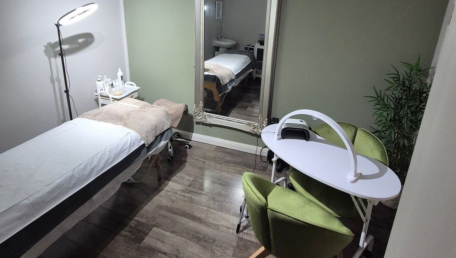 Treatment room at Julia Plas Skin at The House of Hair, Alsager, England, GB, featuring a bed and green chairs.