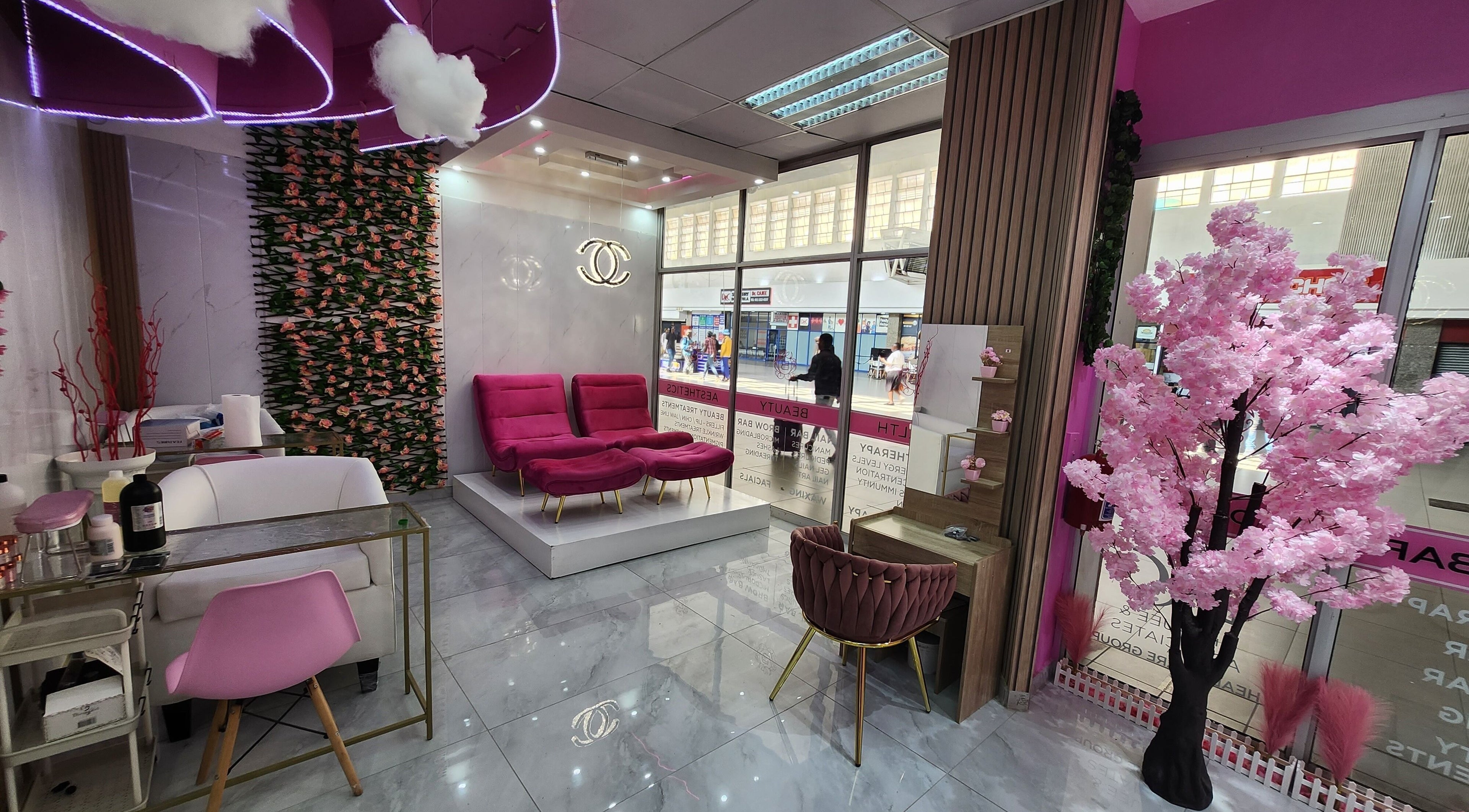 Elegant Beauty Bar interior in Johannesburg, Gauteng, ZA, featuring plush pink seating and floral decor.