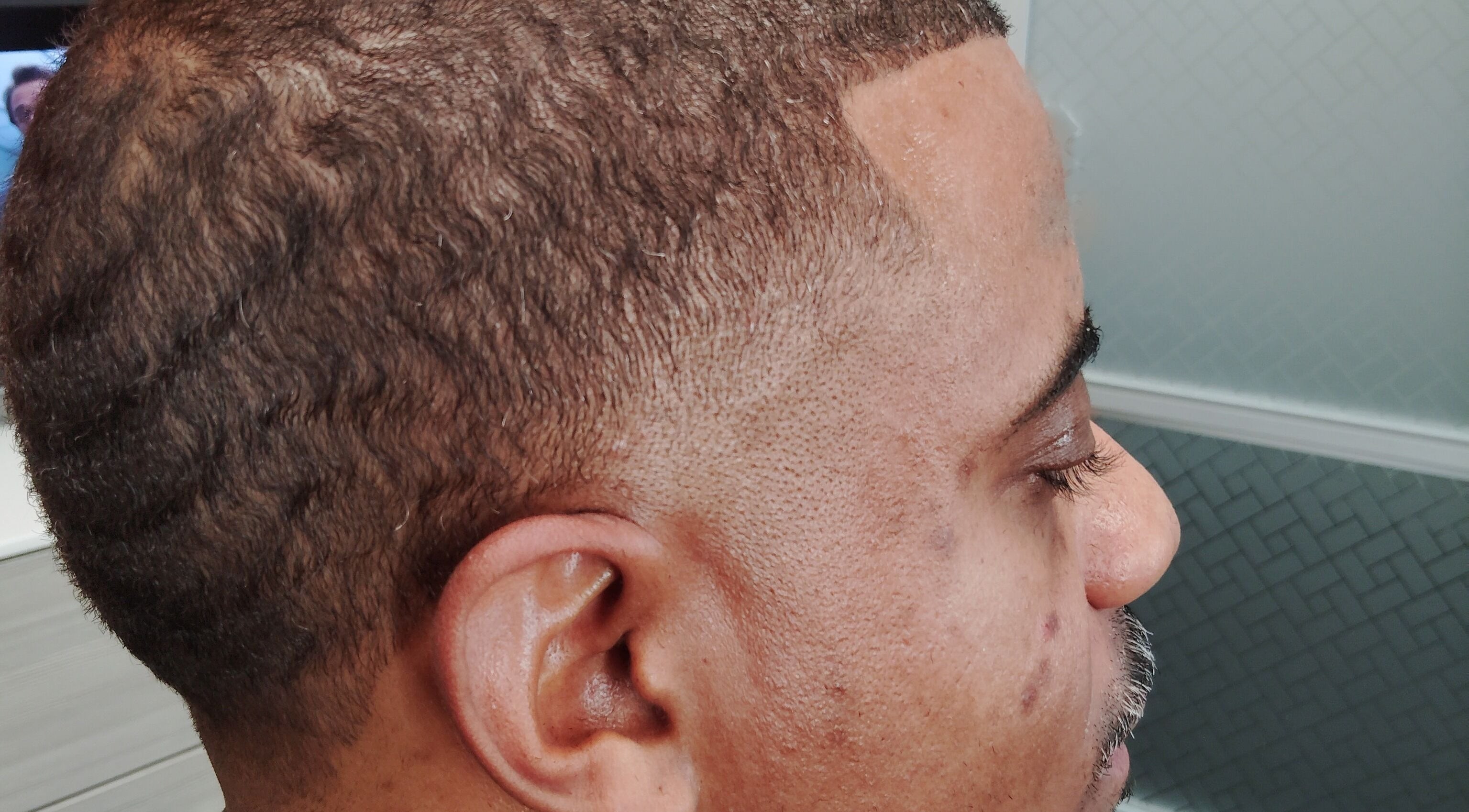 Close-up of a stylish fade haircut at The Introvert Men's Grooming Lounge in Chandler, Arizona, US.