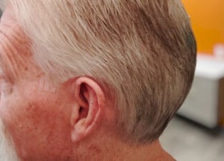 Side profile of a client with a fresh haircut at The Introvert Men's Grooming Lounge, Chandler, Arizona, US.