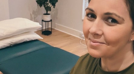 Therapist in serene massage room at Renew Massage and Wellness Uckfield, Uckfield, England, GB.