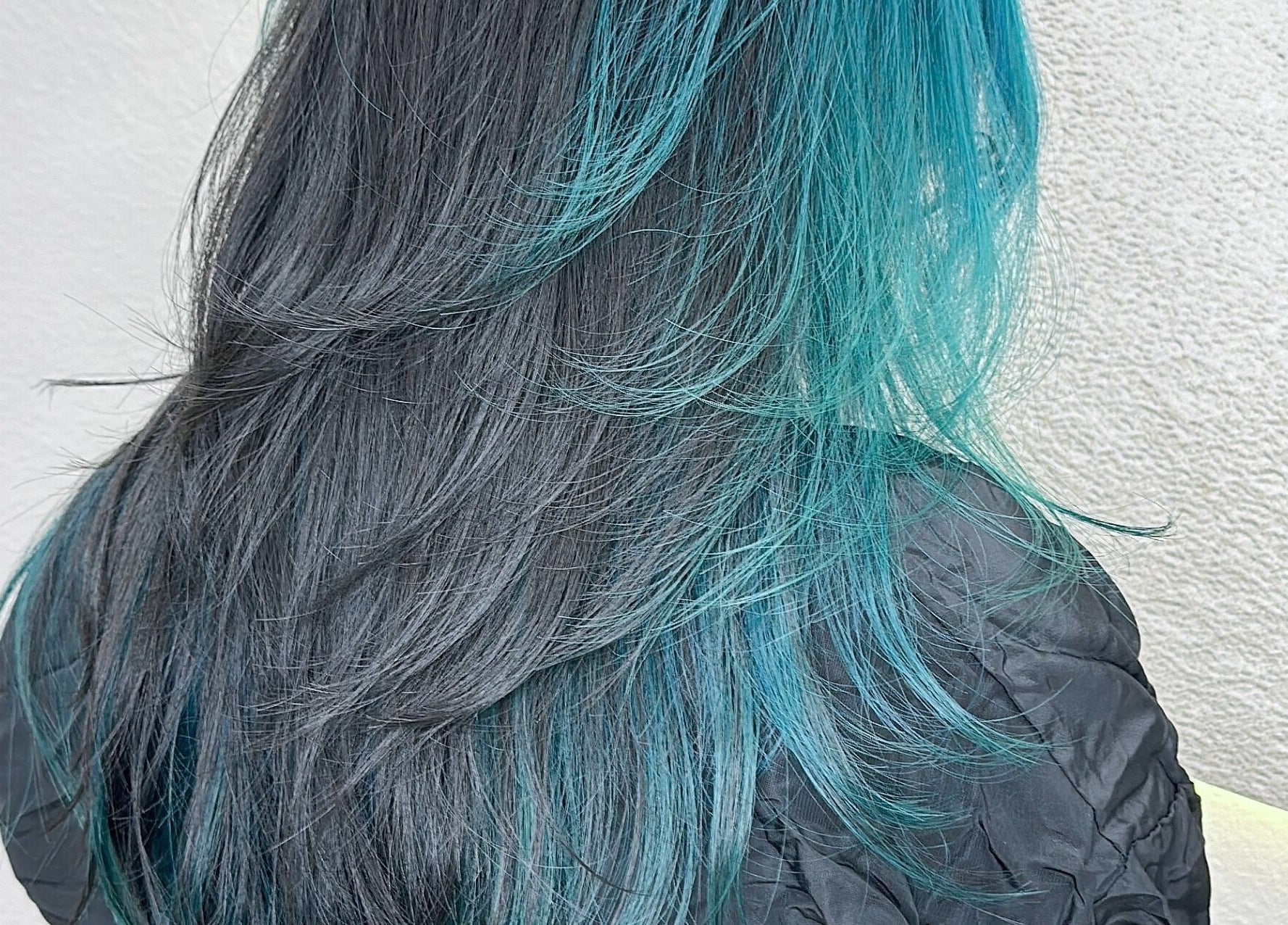 Vibrant teal and black layered hair at Art OS Hair Salon, San Gabriel, California, US.