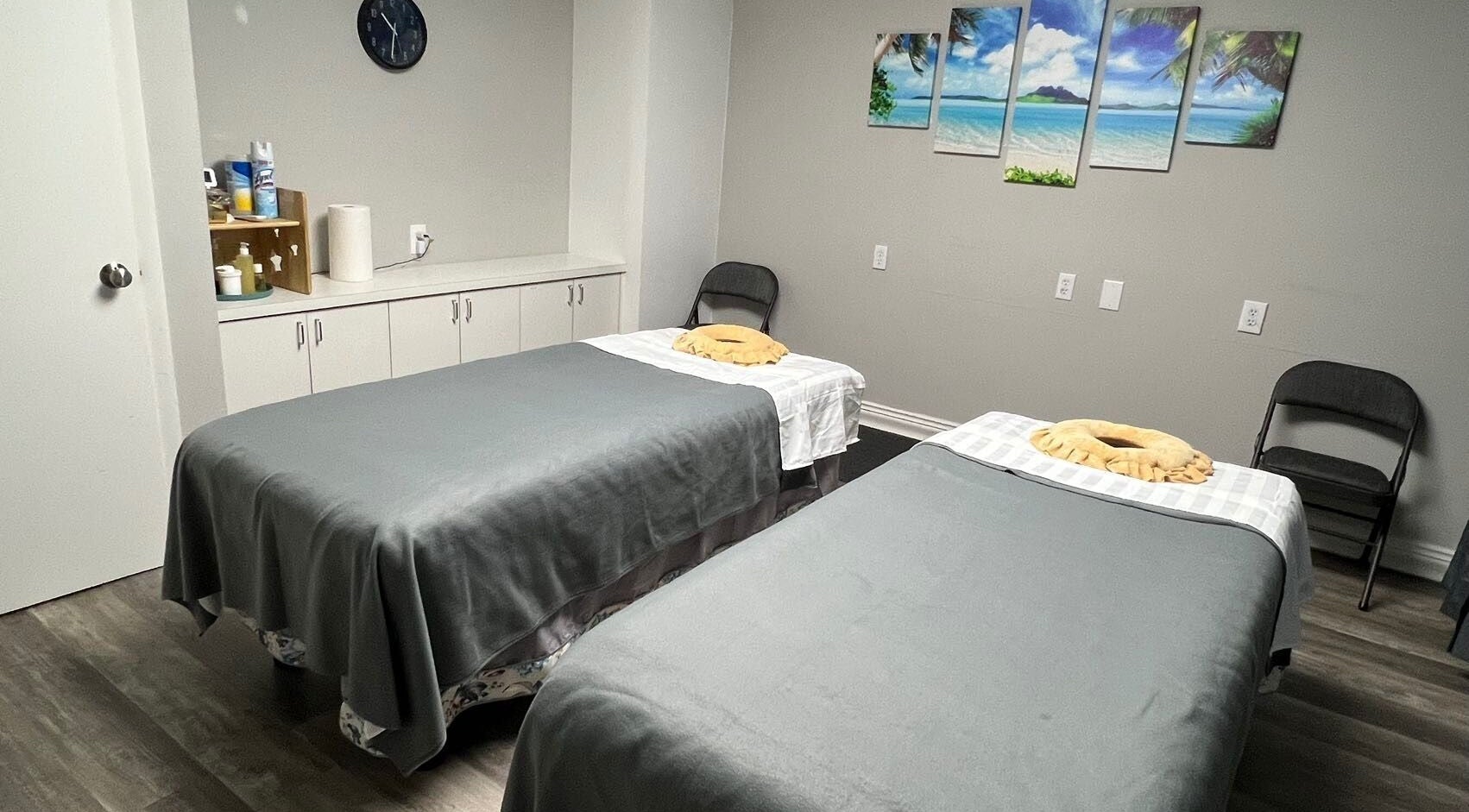 Relaxing massage room with twin beds at ZY Massage Spa in Sarasota, Florida, US, featuring calming decor.