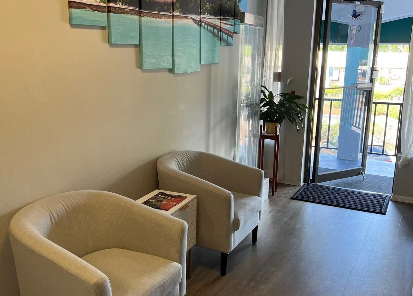 Cozy entrance at ZY Massage Spa, Sarasota, Florida, US with plush chairs and a plant.