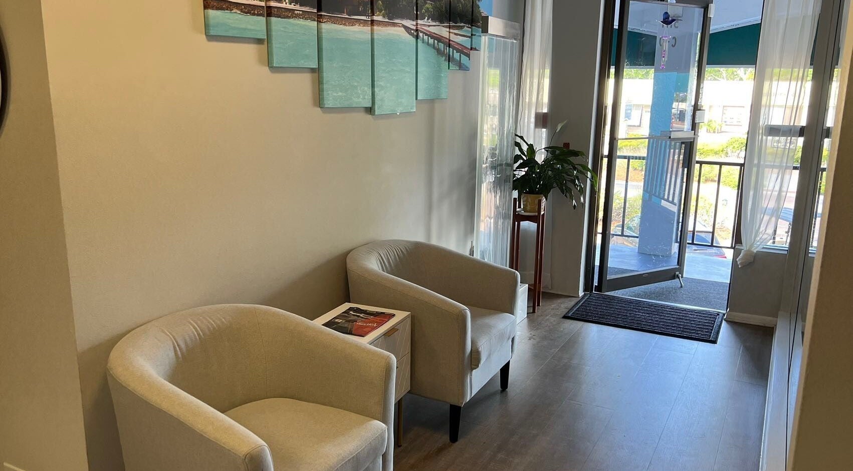Cozy entrance at ZY Massage Spa, Sarasota, Florida, US with plush chairs and a plant.