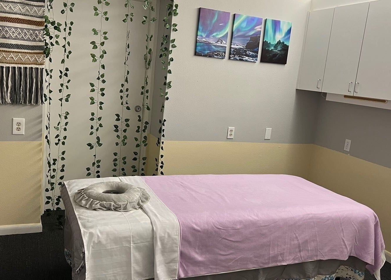 Massage room at ZY Massage Spa in Sarasota, Florida, US, featuring a lavender-covered treatment bed.
