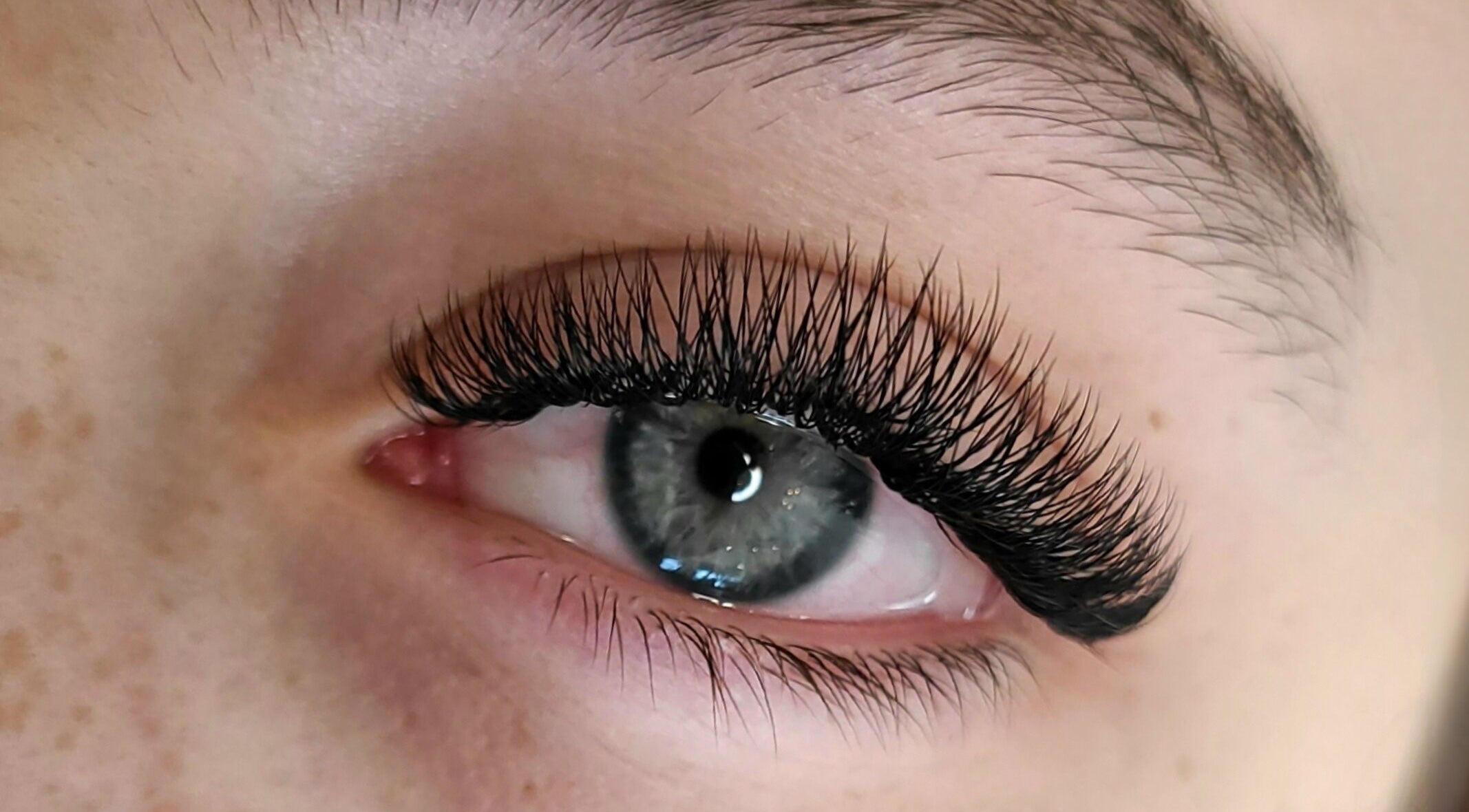 Close-up of lash extensions by Nettb Beauty, Winnipeg, Manitoba, CA, showcasing elegant eye enhancement.