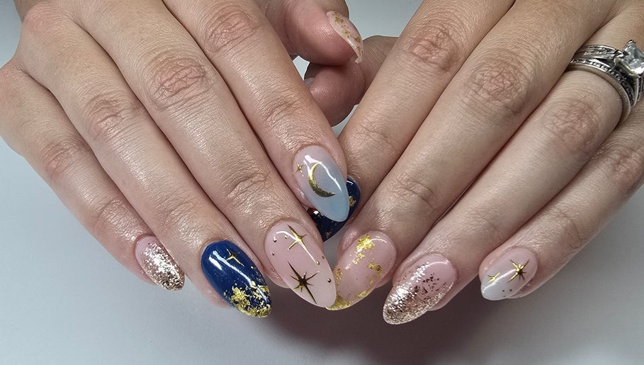 Stunning celestial nail art at Nash & Co Nails, Narangba, Queensland, AU. Blue and gold designs sparkle vividly.