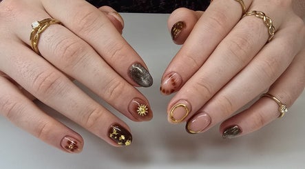 Nash & Co Nails showcases elegant nail art with golden accents in Narangba, Queensland, AU.