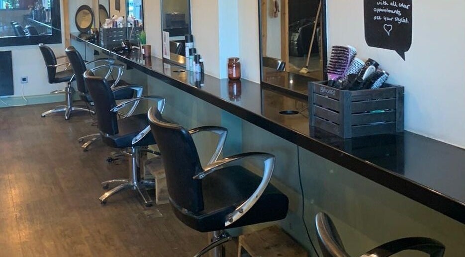 Modern salon chairs and mirrors at House of Hair Foresthall in Forest Hall, England, GB.
