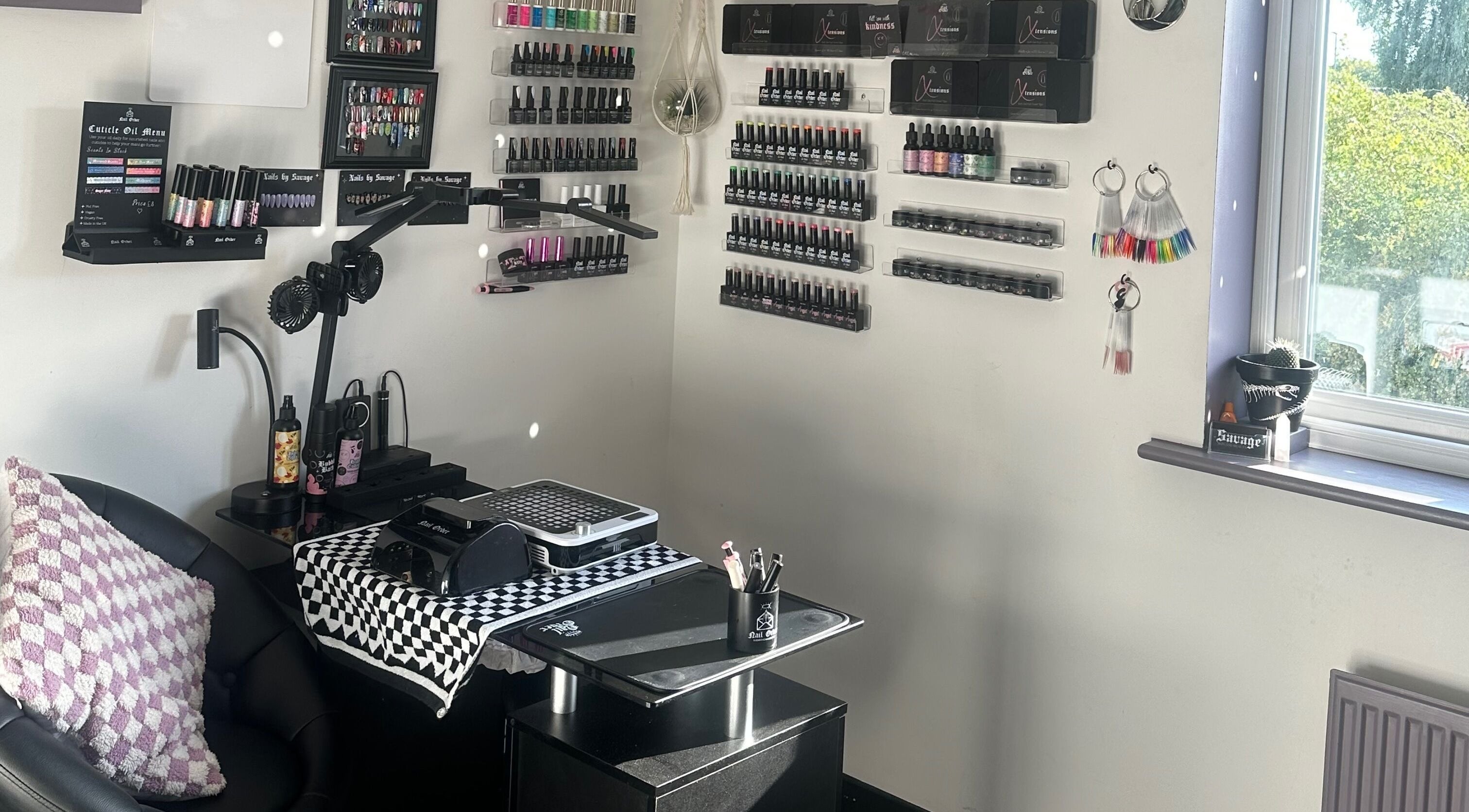 Nail salon interior at Savage Skin and Beauty in Stockton-on-Tees, England showcasing polish displays.