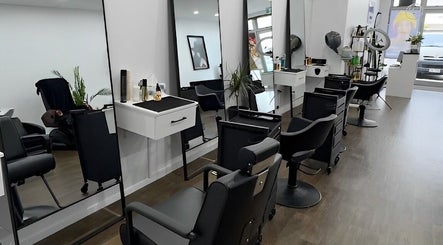 Modern salon interior at Glam Plus Hair & Beauty Salon in Auckland, Auckland, NZ featuring sleek styling chairs.