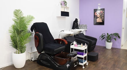 Comfortable salon interior at Glam Plus Hair & Beauty Salon, Auckland, Auckland, NZ with chairs and plant decor.