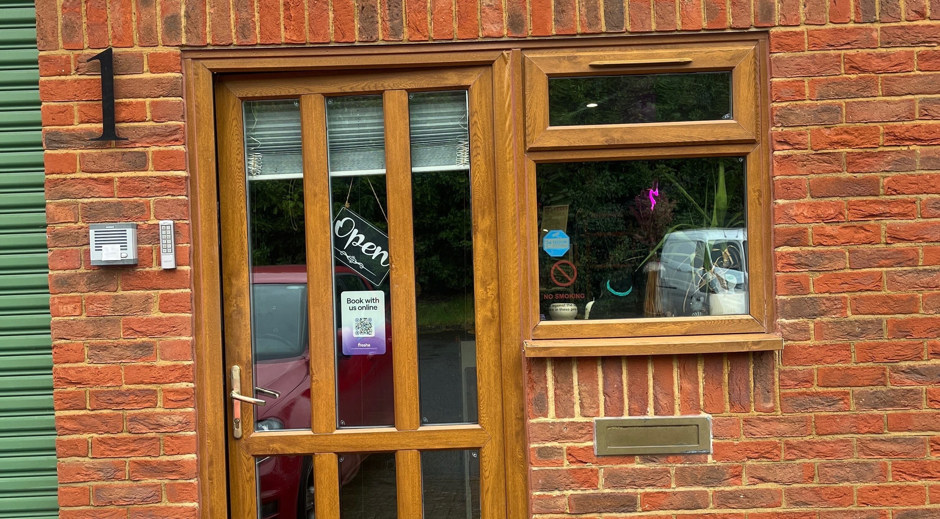 Entrance of Harmony Massage & Skin Studio in Crawley, England, GB with an open sign on wooden door.