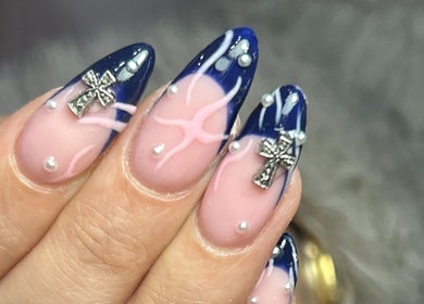 Stylish blue and pink nail art with cross embellishments at Nails by Aims Xo, Bolsover, England, GB.