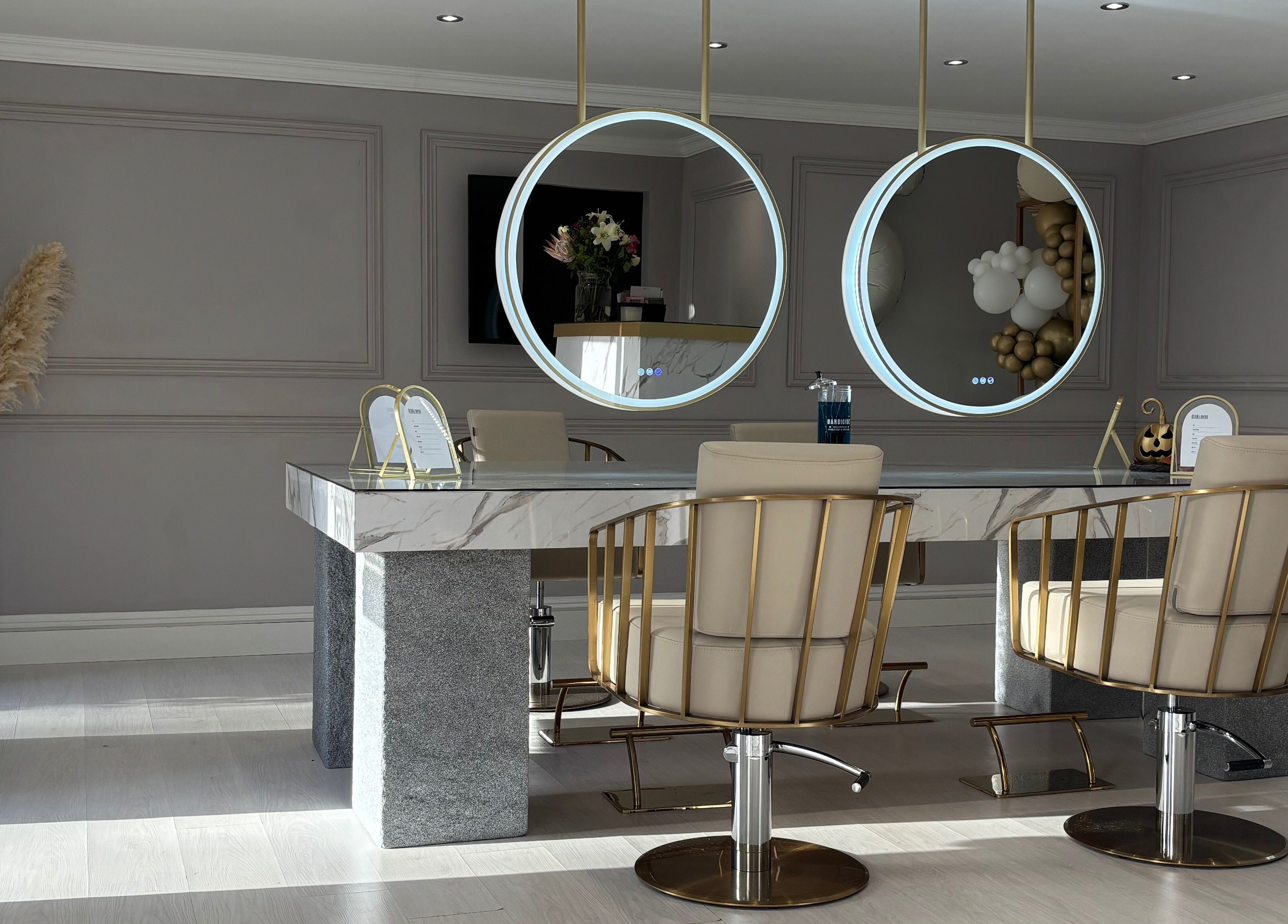 Chic salon interior at Secret Salon, Pucklechurch, England with modern chairs and circular mirrors.