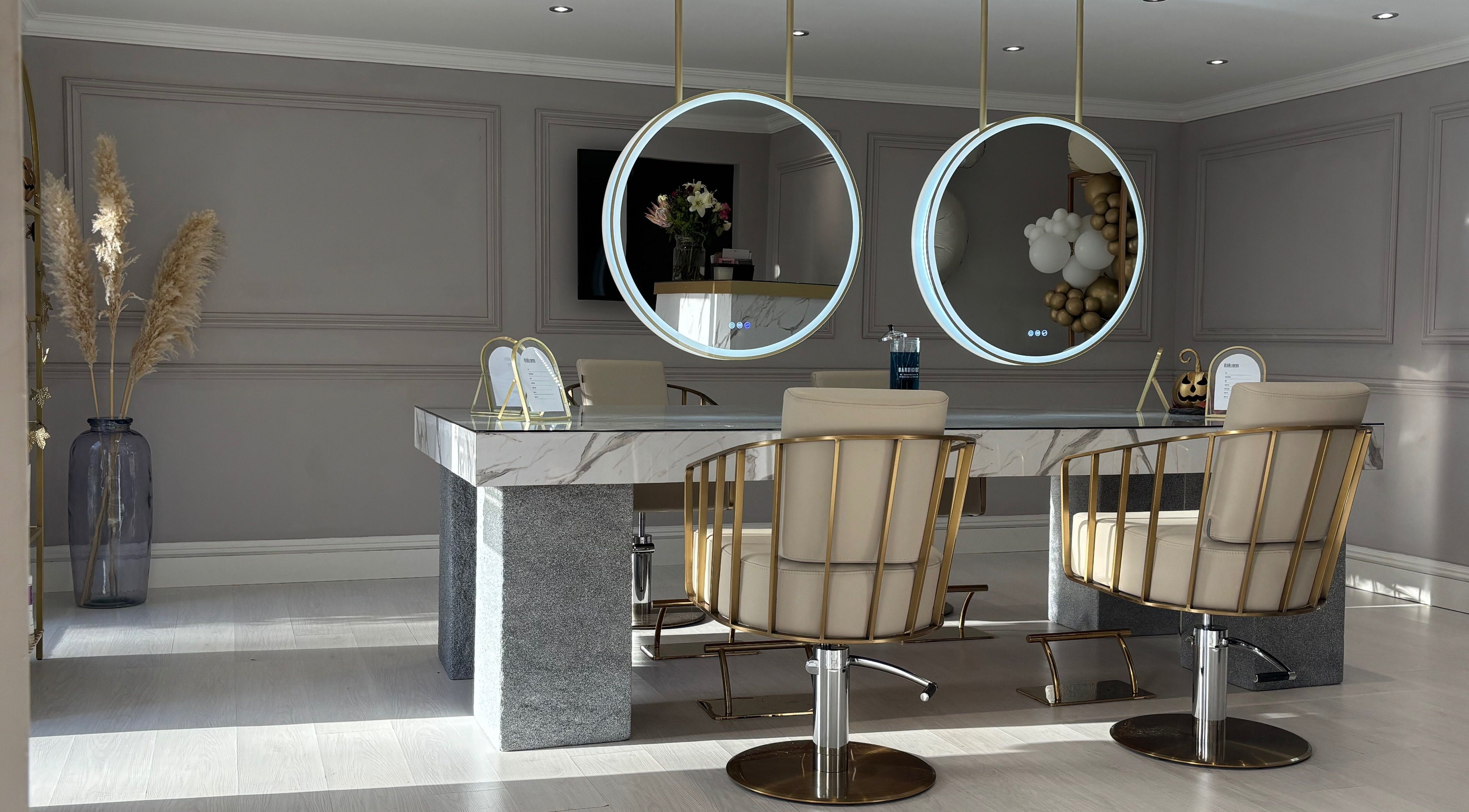 Chic salon interior at Secret Salon, Pucklechurch, England with modern chairs and circular mirrors.