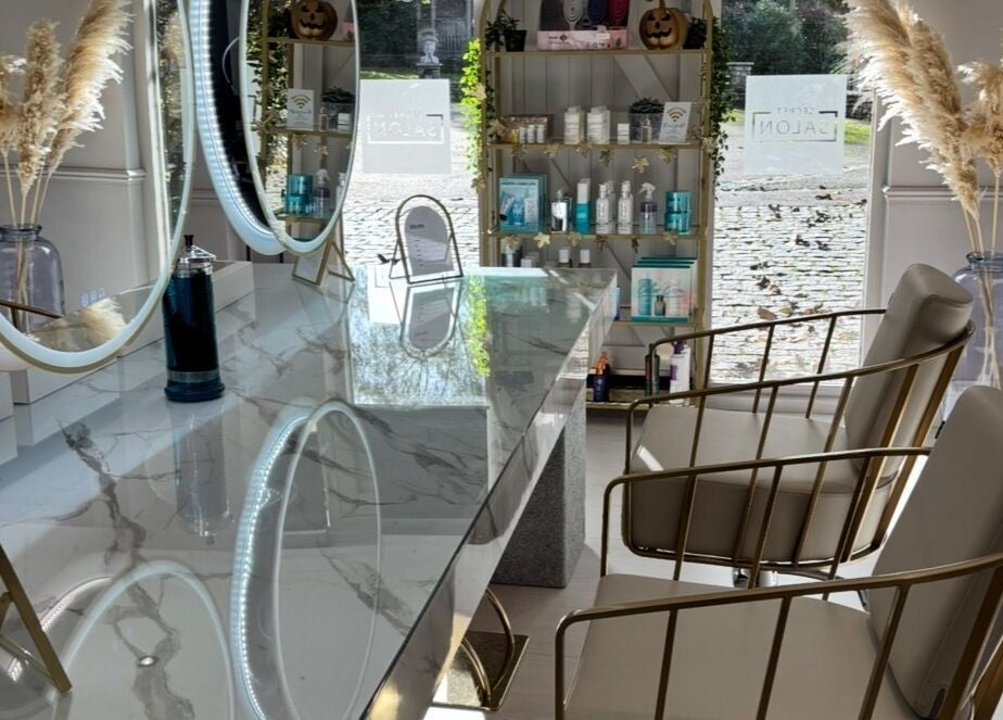 Luxurious marble counter and stylish chairs at Secret Salon, Pucklechurch, England, GB. Elegant mirrors enhance ambiance.